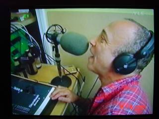 Mike Spenser and microphone in Pirate Radio 603AM studio